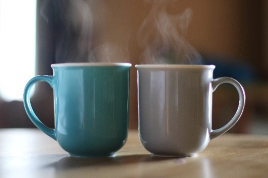 Blue and grey mugs with steam coming out